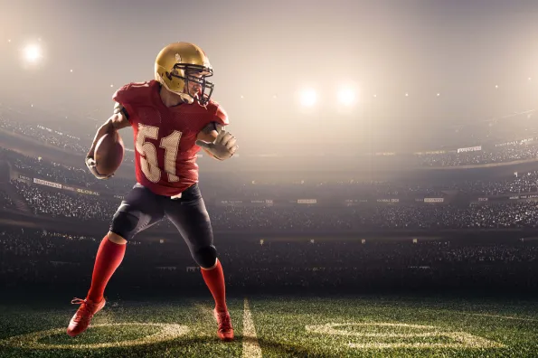 Football player in a crowded stadium.