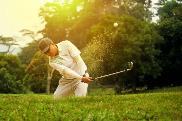 Golfer hitting out of the sand trap