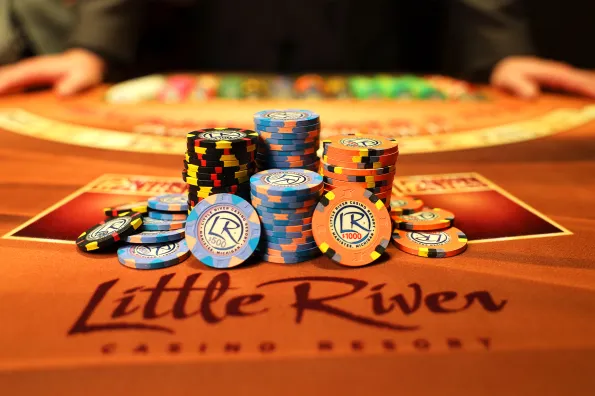 Little River Poker Chips Stacked on a Card Table