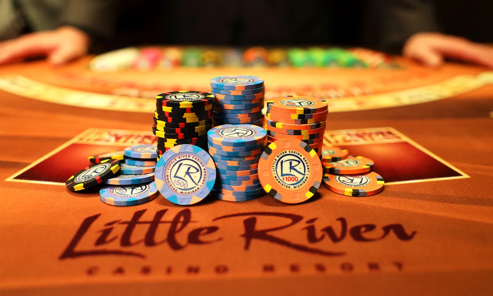 Little River Poker Chips Stacked on a Card Table